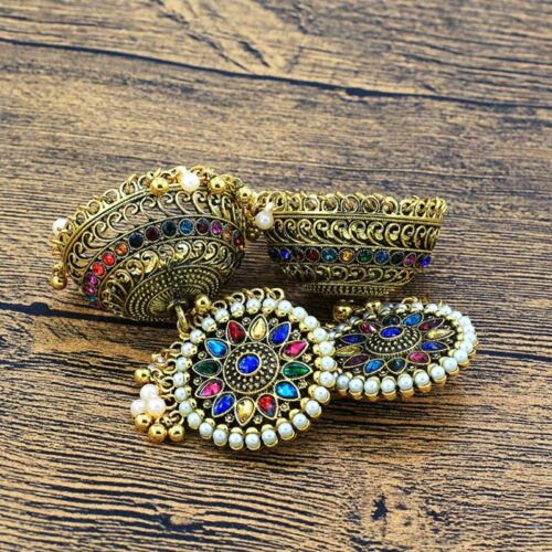 Exquisite earrings with a bohemian style, featuring ornate gold plating and charming bell accents.