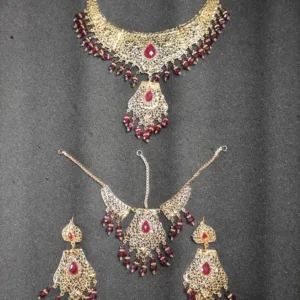 Bridal jewelry set featuring a gorgeous necklace, maang tikka, and earrings, combining traditional charm with timeless elegance.