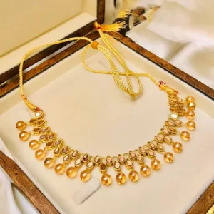 An elegant Kundan choker set in white and golden tones, perfect for adding glamour to any ensemble.