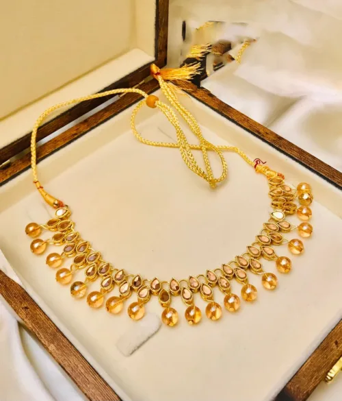 An elegant Kundan choker set in white and golden tones, perfect for adding glamour to any ensemble.