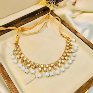 An elegant Kundan choker set in white and golden tones, perfect for adding glamour to any ensemble.