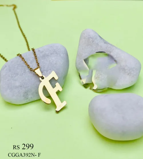 necklace adorned with a capital letter 'F' pendant. The pendant, intricately designed with filigree details, hangs elegantly from a slender chain, adding a touch of sophistication and personalization to the accessory.