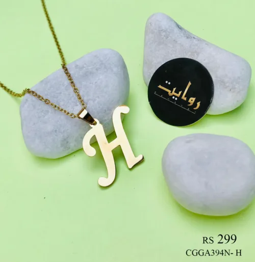 gold necklace adorned with a capital letter 'H' pendant. The pendant, featuring a sleek and modern design, hangs gracefully from a delicate chain, adding a touch of personalized elegance to the accessory.