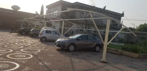 Tensile fabric Car Parking Shed in Pakistan to protect vehicles from sun and rain protection with an elegant look. Image showing Work in Process Shed Structure.