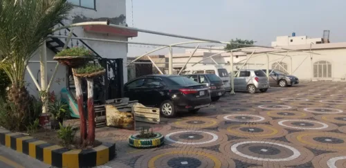 Tensile fabric Car Parking Shed in Pakistan to protect vehicles from sun and rain protection with an elegant look. The second view shows the Work in Process Shed Structure.