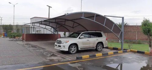 an innovative car parking shade design at the best price in Pakistan is now available. This modern car parking shed features a tensile fabric membrane for perfect vehicle protection from sun and rain. Tensile fabric structures are more reliable and long-lasting. This car parking shed was installed at Sadaqat Textile, Faisalabad