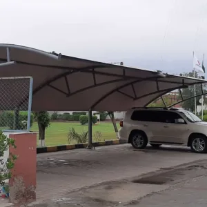 an innovative car parking shade design at the best price in Pakistan is now available. This modern car parking shed features a tensile fabric membrane for perfect vehicle protection from sun and rain. Tensile fabric structures are more reliable and long-lasting. This car parking shed was installed at Sadaqat Textile, Faisalabad