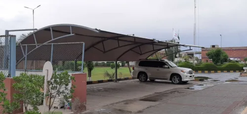 an innovative car parking shade design at the best price in Pakistan is now available. This modern car parking shed features a tensile fabric membrane for perfect vehicle protection from sun and rain. Tensile fabric structures are more reliable and long-lasting. This car parking shed was installed at Sadaqat Textile, Faisalabad