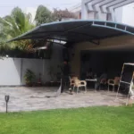 Portable garage shade with tensile fabric membrane for space enhancement and reliable weather protection for vehicles and outdoor areas.